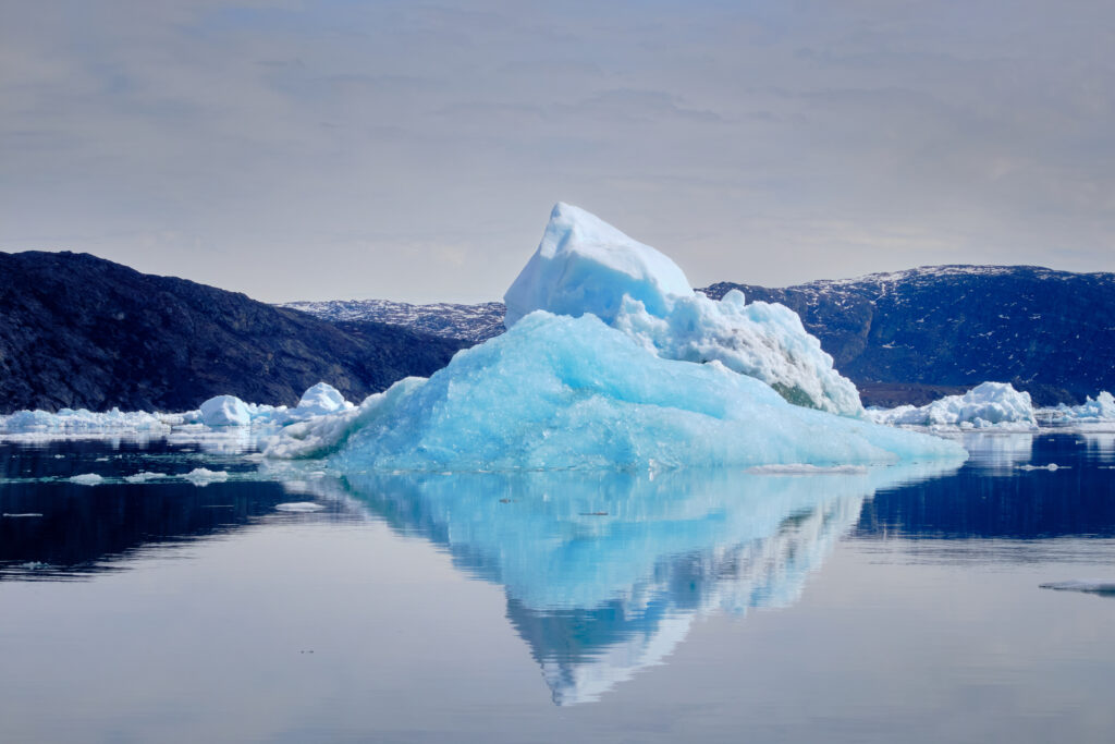 Pyramid iceberg reflected in the water the Nuuk Icefjord on a boat tour with Guide to Greenland