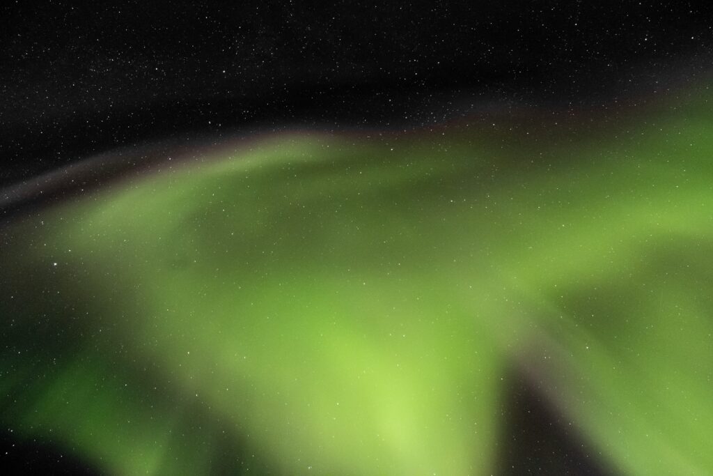Massive chunk of northern lights on a starry night sky