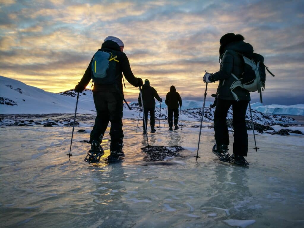 Group of people snowshoeing across the ice