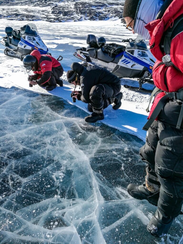 Man taking pictures of the sea ice