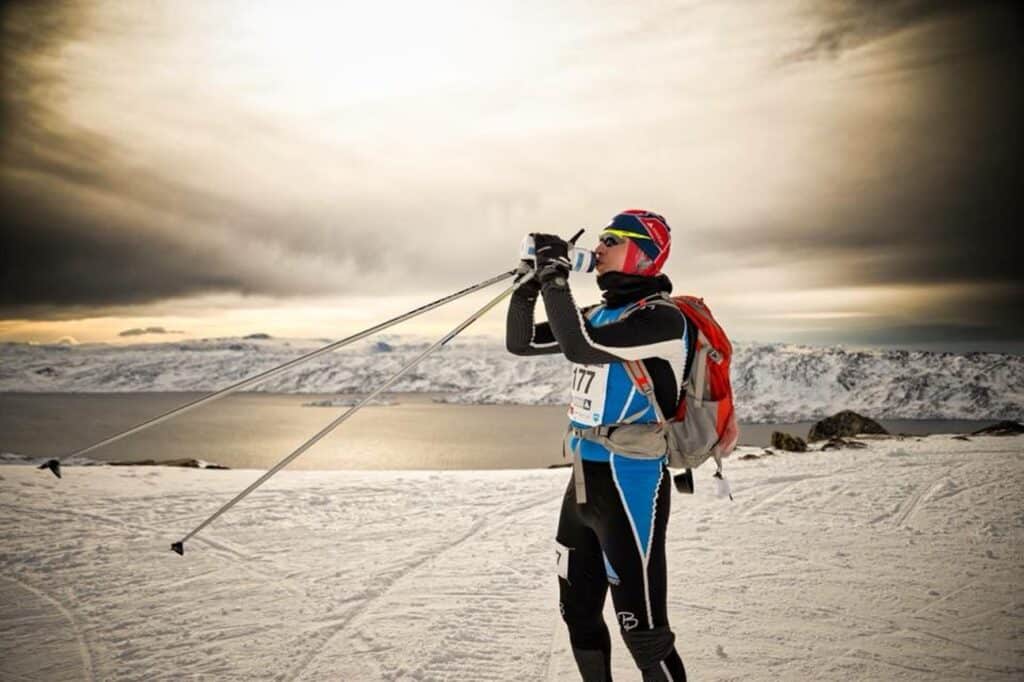 Man taking a sip of water during Arctic Circle Race