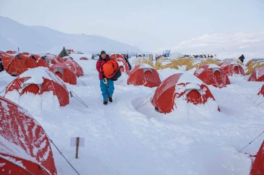 A man finding his way through the red and yellow tents