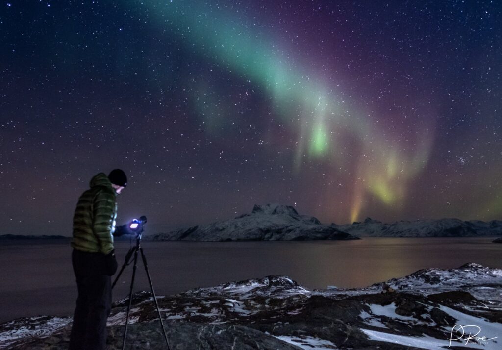Man taking a picture of the northern lights