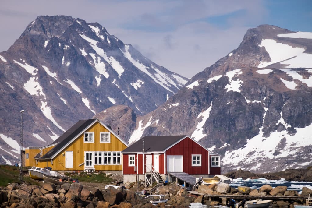 Colorful houses with impressive views of the mountains in Kulusuk in East Greenland