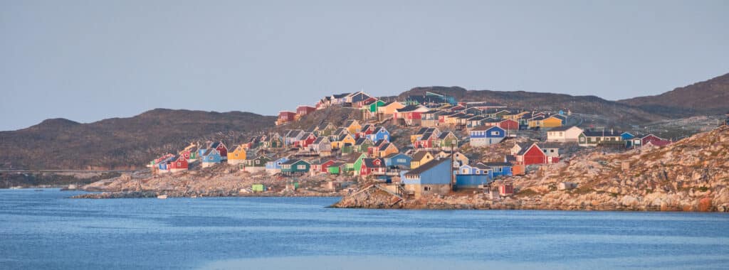 Colorful houses of Aasiaat line the shores of Disko Bay
