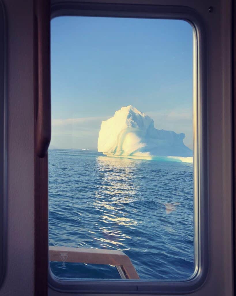 Iceberg in water seen from a boat