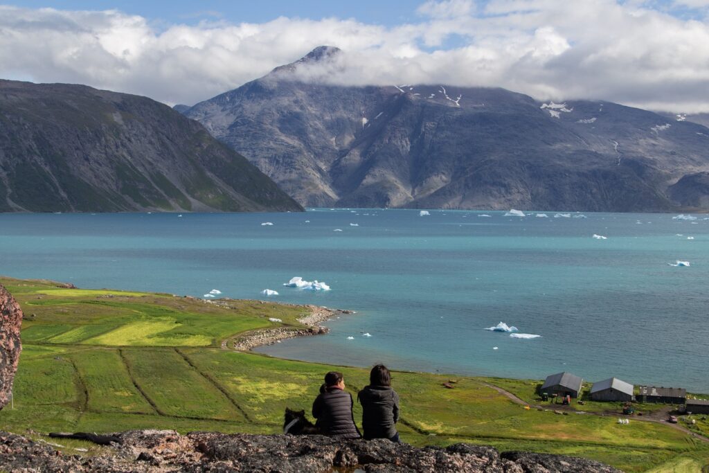 Two people on top of a mountain enjoying the view