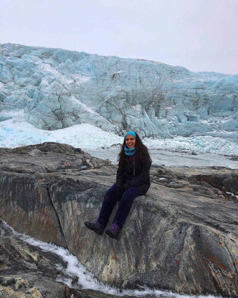 Woman sitting in front of a glacier