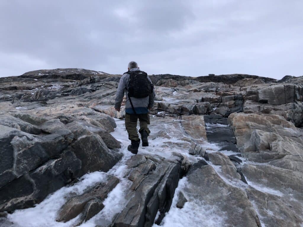 Man walking up a waterfall
