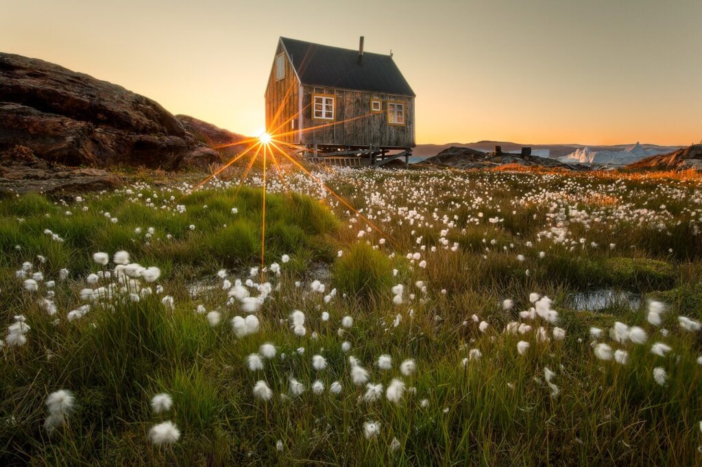 Small greenlandic hut pictured at sunrise