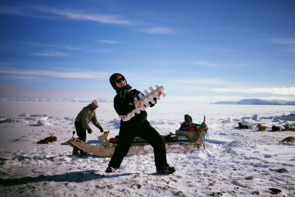 Woman standing in front of a dog sled