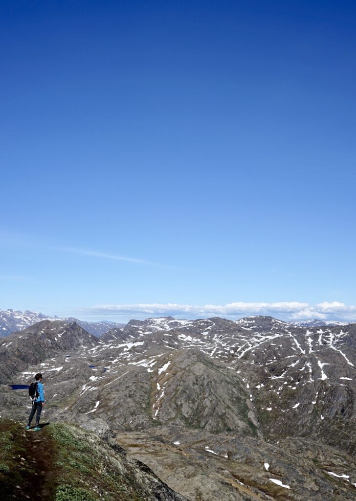 Man looking towards snowy mountain tops