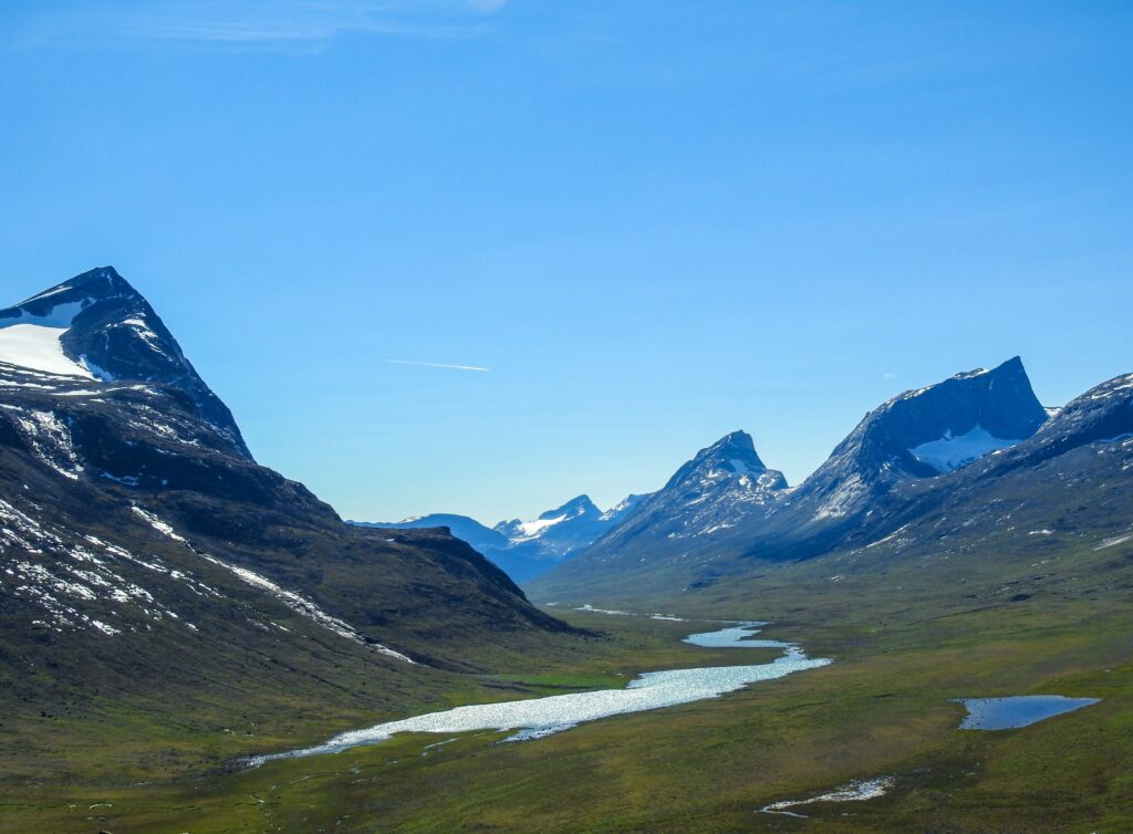 Landscape with a lake and snowy mountain tops