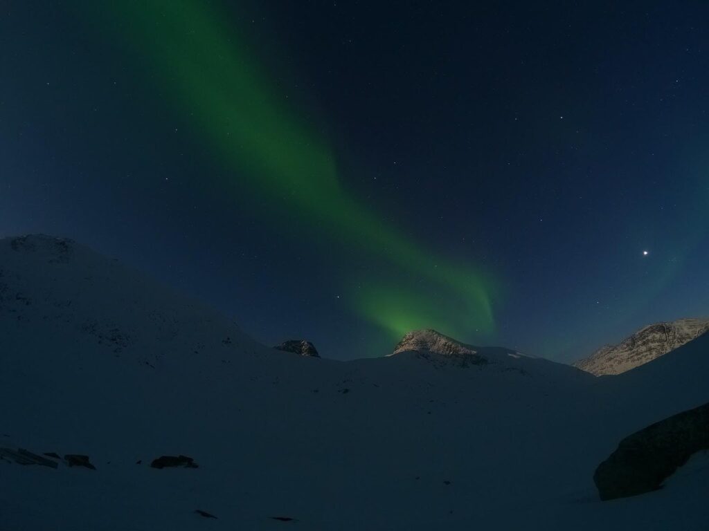 Northern lights over a mountain top