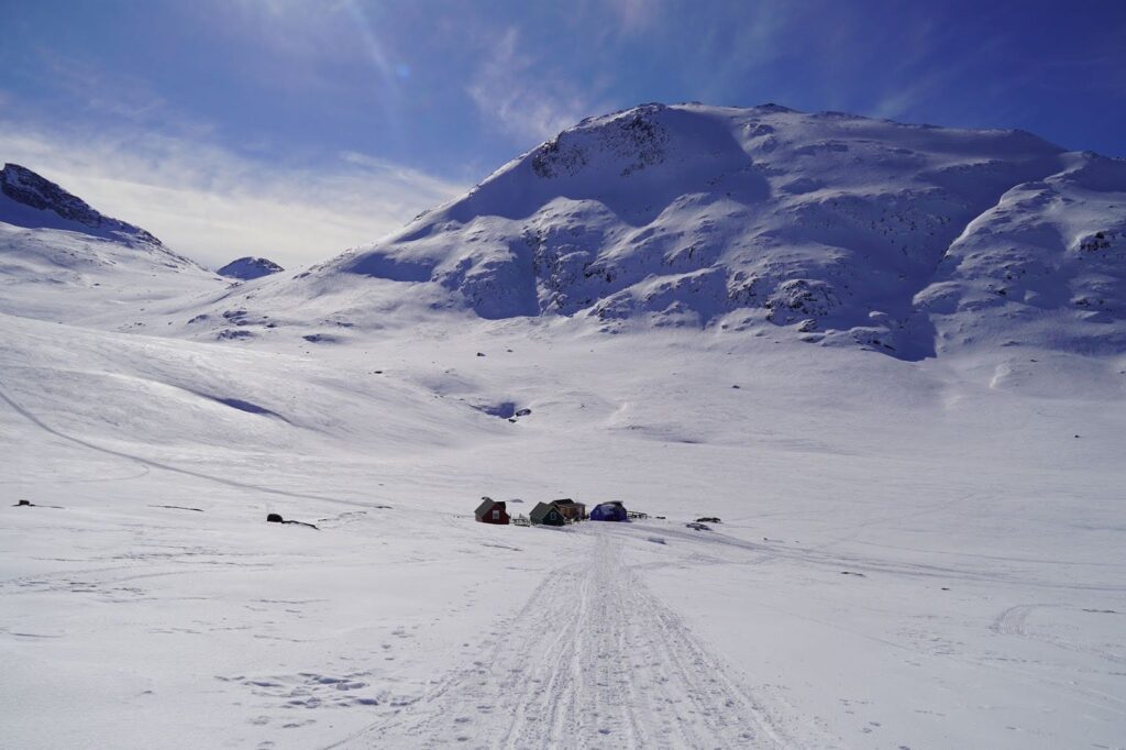 Small cluster of huts surrounded by snow