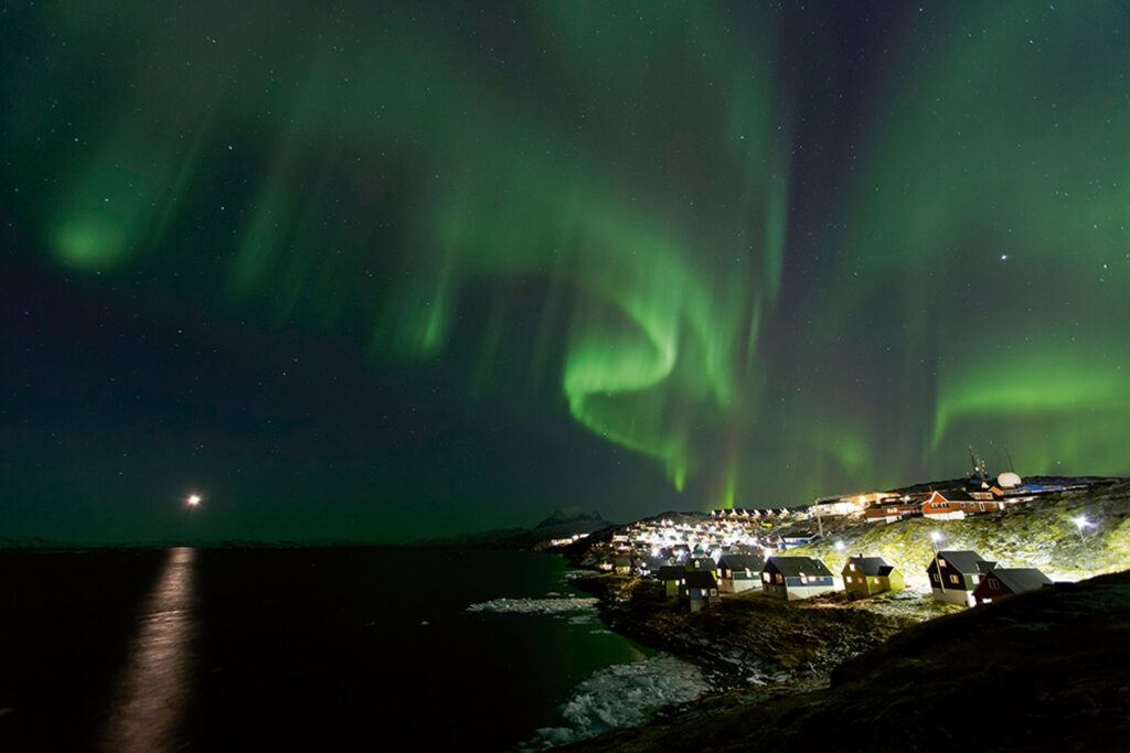 Beautiful northern lights over houses in Greenland