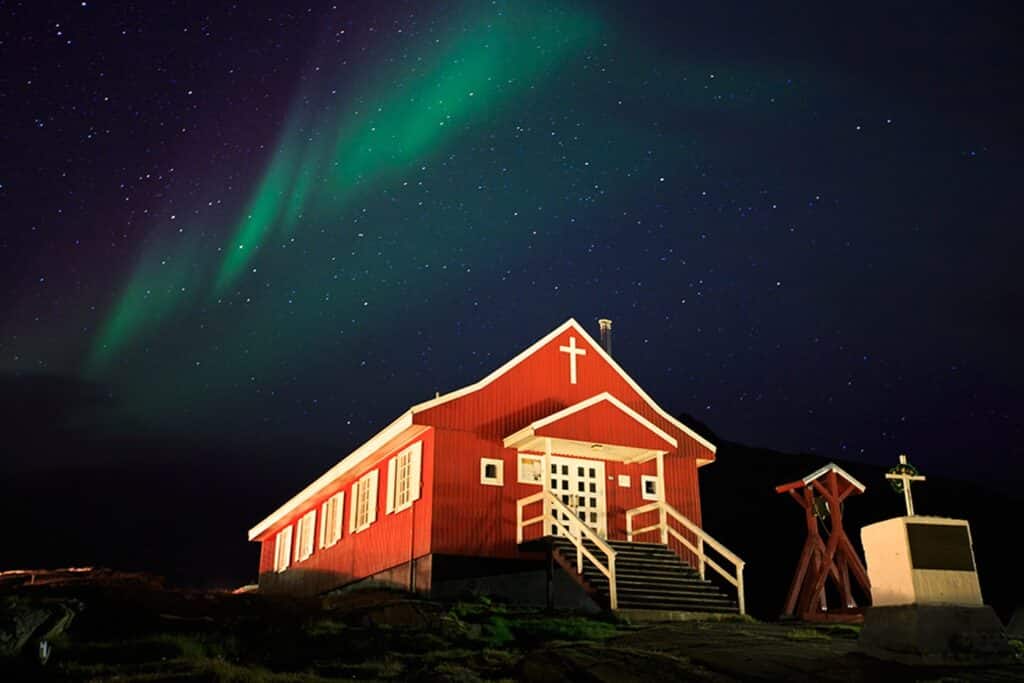 Northern lights over a small church in Greenland