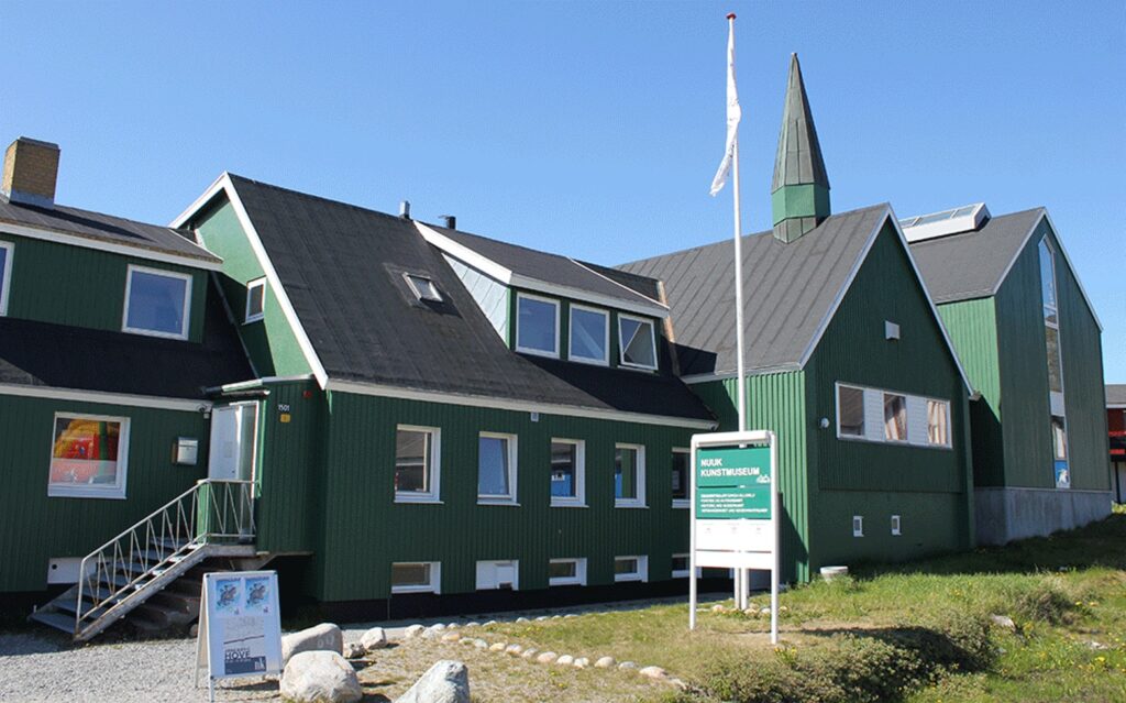 The green facade of the old church that now is Nuuk Art Museum