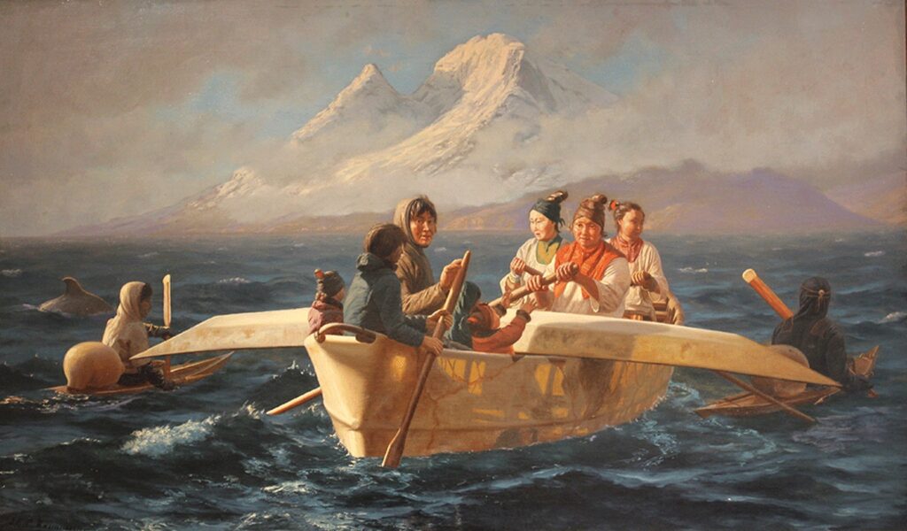 Inuits sailing in traditional kayaks in the fjord in Greenland
