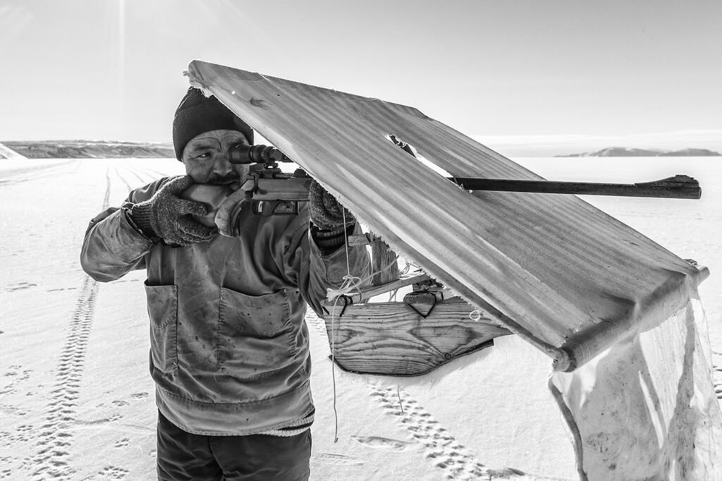 Greenlandic hunter shooting his riffle