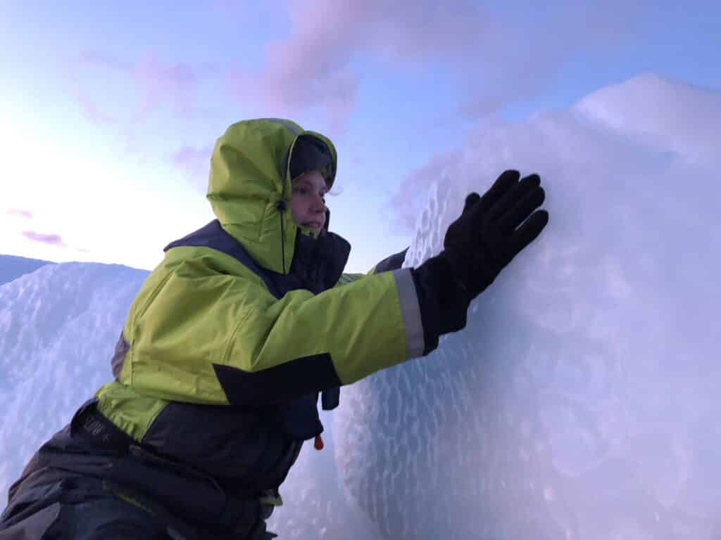 Woman touching an iceberg