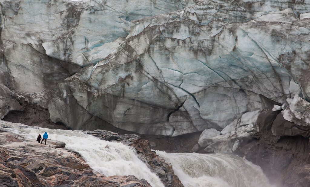 People standing next to the Russell Glacier in Kangerlussuaq