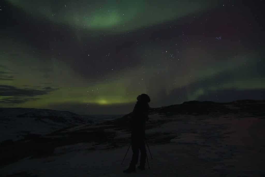 Photographer taking pictures of the northern lights in Kangerlussuaq