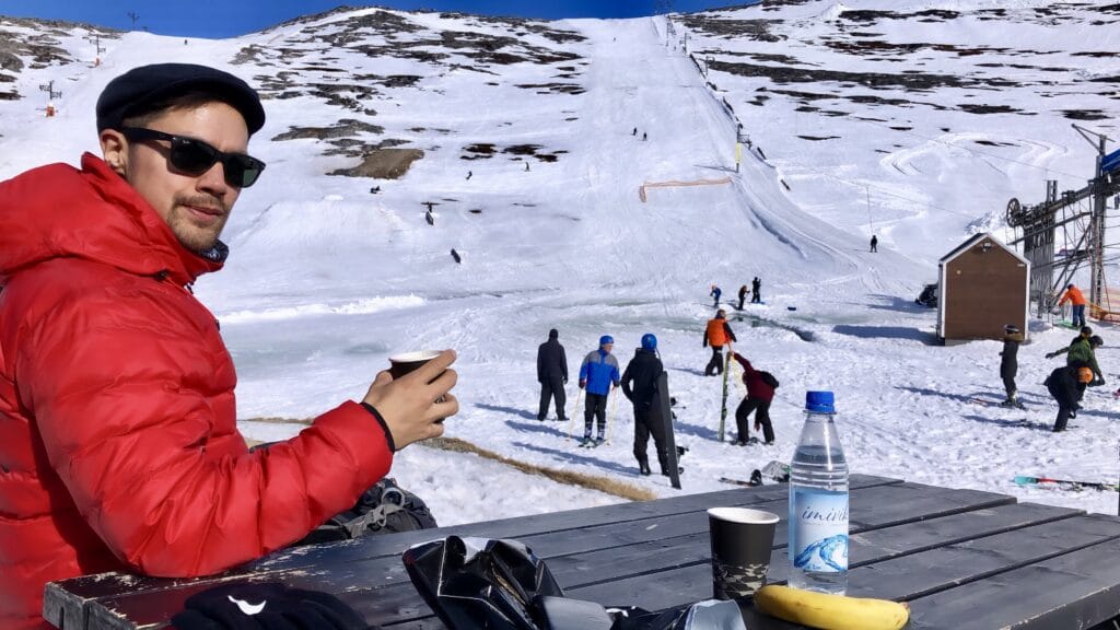 Man enjoying a cup of coffee at the ski slope