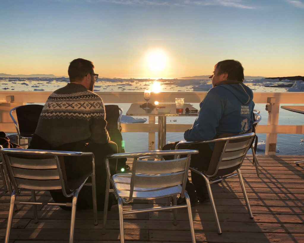 Couple enjoying the midnight sun in Ilulissat