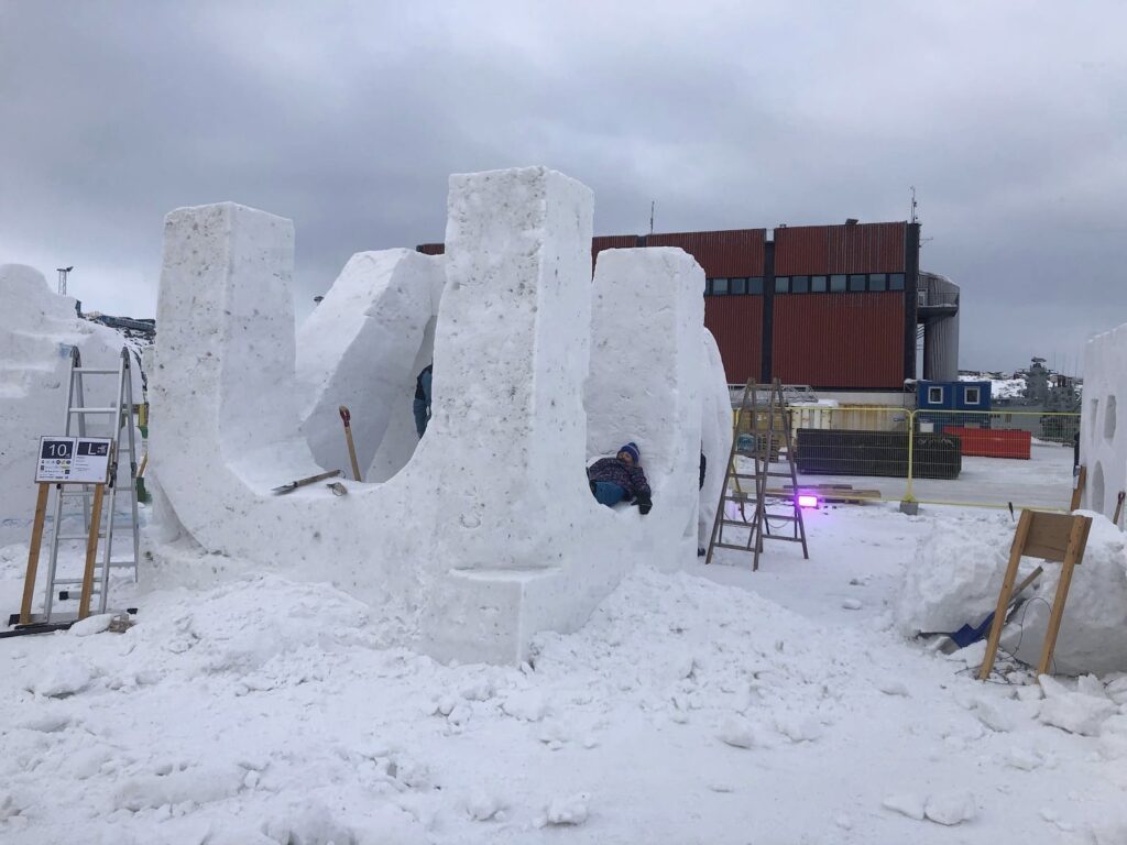 Man taking a nap on a snow sculpture