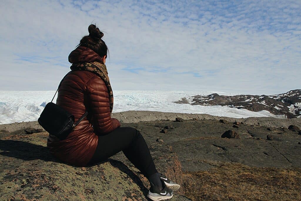Woman looking at the ice sheet in Kangerlussuaq