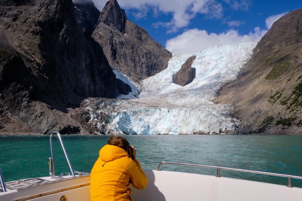 Photographer taking pictures of one of the many glaciers in the Eternity Fjord north of Maniitsoq - Guide to Greenland