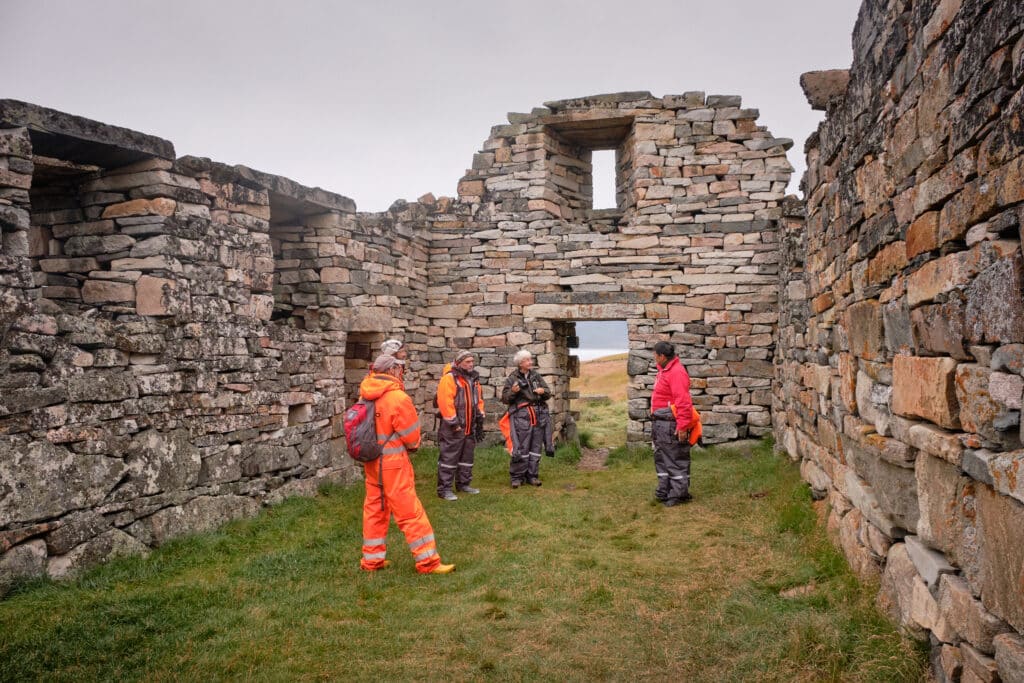 Learning about the Hvalsey Church on a tour - Qaqortoq