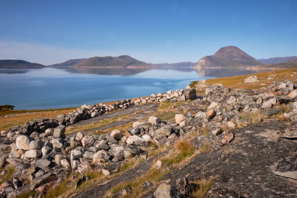 Remains of the stables at Hvalsey with the church in the background - Qaqortoq
