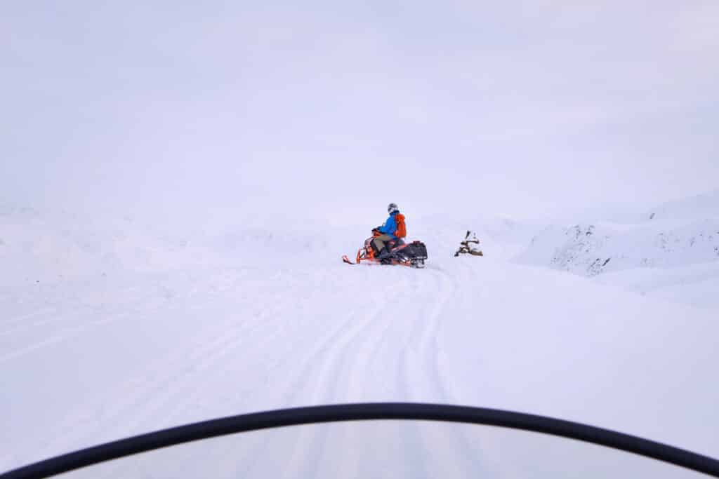 View from the drivers seat of a snowmobile near Sisimiut