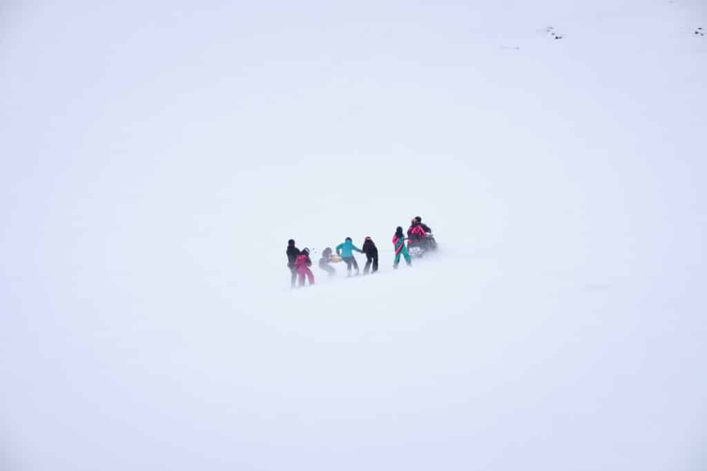 Kids getting towed behind a snowmobile at Siismiut ski center