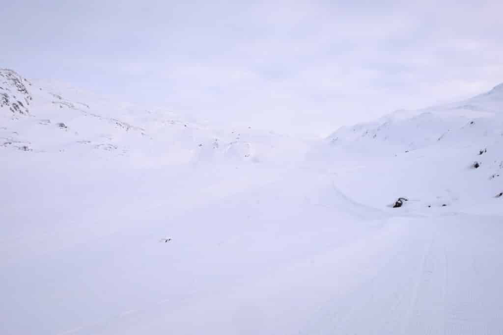 Snowmobile and dogsled route is difficult to see in the flat light near Sisimiut