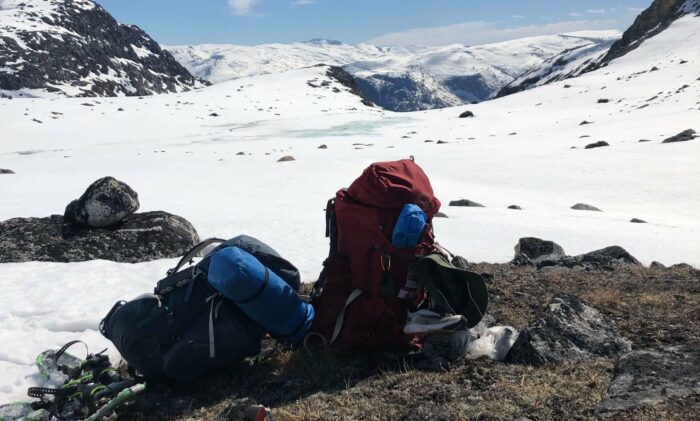our backpacks in the snowy mountains