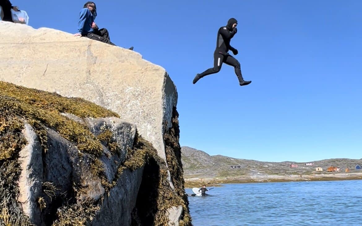 Jumping right in, knowing that the wetsuit will help with the cold water.